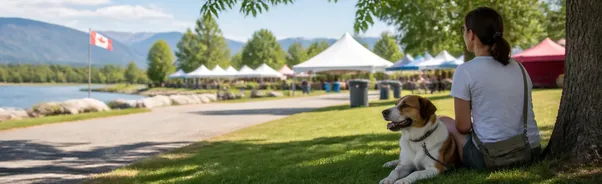 Dog with owner near a shaded area at an outdoor public event